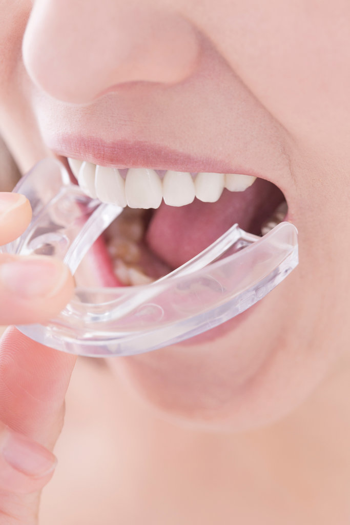 woman putting on mouthguard